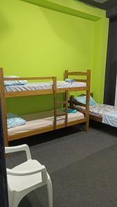 two bunk beds in a room with a green wall at Hostel Salvador Meu Amor in Salvador