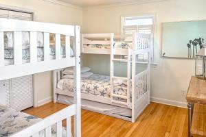 a bedroom with two bunk beds and a desk at Sea La Vie in Virginia Beach