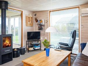 a living room with a couch and a fireplace at Three-Bedroom Holiday home in Lemvig 1 in Lemvig
