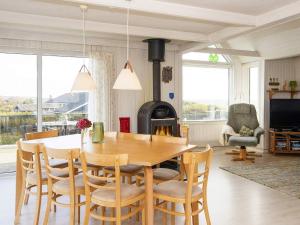 a dining room with a table and a wood stove at Three-Bedroom Holiday home in Lemvig 6 in Lemvig