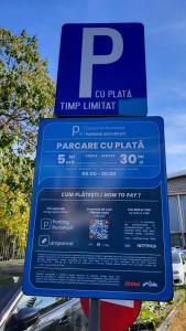 a blue parking sign in front of a parking garage at Traditional Romanian Apartments Old Town City in Bucharest