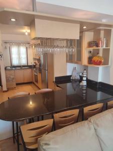 a kitchen with a counter and a table and chairs at Pueblo Viejo Lecheria in El Morro de Barcelona