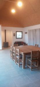 a large wooden table and chairs in a room at La Cappella Casa Quincho in Sierra de los Padres