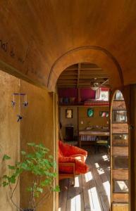 a room with an archway with a couch and a table at La Troje Cabañas in Tepoztlán
