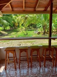 a window with three chairs and a table in a room at Surf Shack Room #2 in Pavones