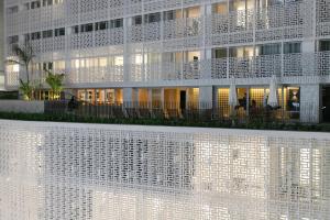 a building with a white facade with lights on it at Tabas - Renata Edifício - Vila Buarque in Sao Paulo