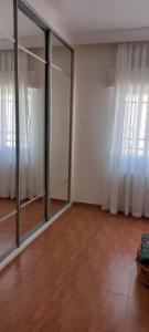 an empty room with sliding glass doors and curtains at عمان الاردن الدوار الخامس in Amman
