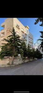 a large building with trees in front of it at عمان الاردن الدوار الخامس in Amman