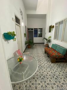 a living room with a glass table and a couch at Believer Hostel in Santa Marta