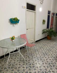 a room with a table and chairs on a tile floor at Believer Hostel in Santa Marta