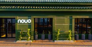 a noco store with potted plants in front of it at NOVO Hotel Boutique in Ríohacha