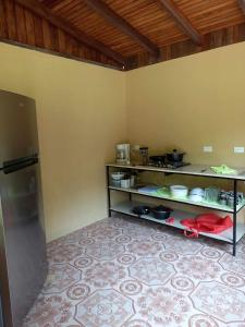 a kitchen with a shelf with food on it at Surf Shack Room #3 in Pavones