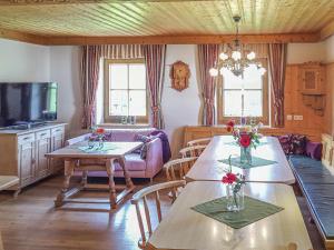 a living room with two tables and a couch at Landhaus Schiedhof in Neukirchen am Großvenediger