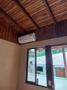 a room with a window and a air conditioner on the ceiling at Surf Shack Room #2 in Pavones