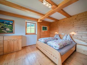- une chambre avec des murs en bois et un lit dans un dortoir dans l'établissement Flicklhof XL, à Hopfgarten im Brixental
