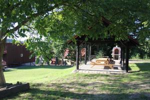 a gazebo with a picnic table in a park at Rafaello Pokoje Gościnne in Łagów