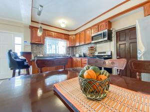 a bowl of fruit on a table in a kitchen at Paradise Villa in Port Elizabeth