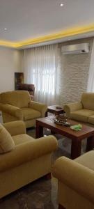 a living room with couches and a coffee table at جبل عمان الدوار الخامس in Amman