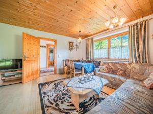 a living room with a couch and a table at Schergrub in Kirchberg in Tirol