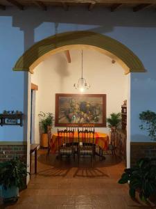 een eetkamer met een tafel en een schilderij aan de muur bij Mi casita “Chinco” estrellas in Zapatoca