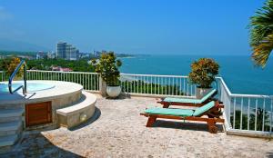 a patio with a hot tub and two lounge chairs at Hotel Irotama XXI in Santa Marta +44 photos