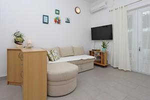 a living room with a couch and a tv at Apartments with a parking space Kornic, Krk - 415 in Kornić