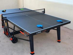 a ping pong table with two ping pong balls on it at Gîte familial avec piscine privative chauffée, terrasse sur le Loir et proche du Zoo de La Flèche - FR-1-410-329 in La Flèche
