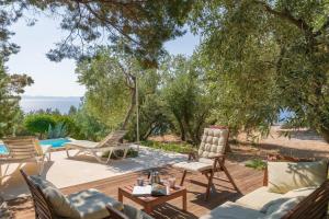 a patio with furniture and a view of the water at Holiday house with a swimming pool Podobuce, Peljesac - 21882 in Orebić