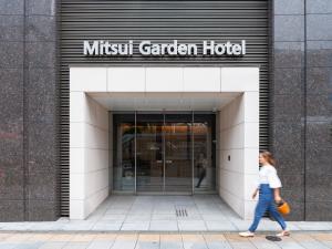 a woman walking into a music garden hotel at Mitsui Garden Hotel Ueno - Tokyo Reopened in July 2023 in Tokyo