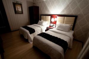Postel nebo postele na pokoji v ubytování Pariss Hotel