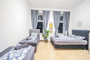 a living room with two beds and a couch at Comfort Quad room HN in Vienna