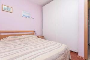 a bedroom with a bed in a white room at Apartments with a parking space Ravni, Labin - 12891 in Ravni