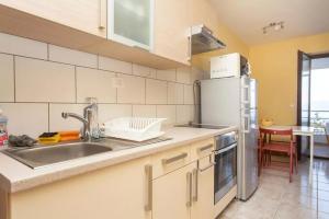 a kitchen with a sink and a refrigerator at Apartments with a parking space Ravni, Labin - 12891 in Ravni