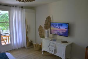 a living room with a flat screen tv on a wall at Studio TI BO 4 in Saint Martin