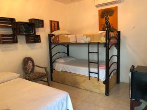 a room with two bunk beds in a room at Posada DORA in Isla Mujeres