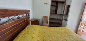 a small bedroom with a bed and a staircase at Cómoda habitación con baño privado in Sucre