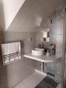 a bathroom with a sink and a mirror at Cómoda habitación con baño privado in Sucre