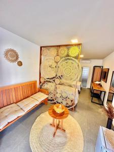 a living room with a couch and a table at Noah Hostel & Chale in São Miguel do Gostoso
