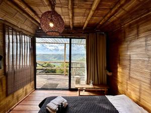 1 dormitorio con cama y ventana grande en Hakuna Matata Glamping timon, en Salento