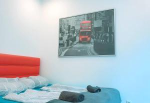 a picture of a red double decker bus on a street at Comfort Triple room HN in Vienna