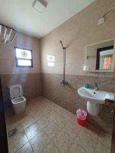 a bathroom with a toilet and a sink at Terhal salalah 1 in Salalah