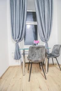 a dining room with a table and two chairs and a window at Modern Double room HN in Vienna