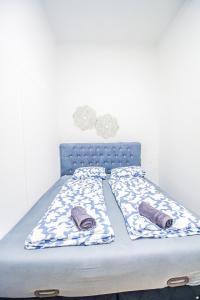 a bed with a blue headboard and pillows on it at Modern Double room HN in Vienna
