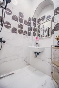 a white bathroom with a sink and a tub at Modern Double room HN in Vienna