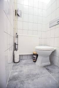 a white bathroom with a toilet and a tub at Modern Double room HN in Vienna