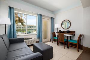 a living room with a couch and a table at Sand Rose Beach Resort in South Padre Island