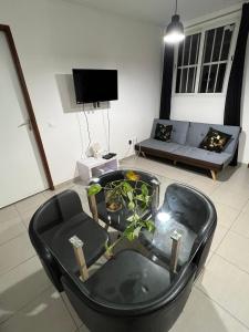 a living room with a black chair and a couch at Kasentof in Cayenne