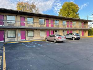 two cars parked in a parking lot in front of a building at Express Inn-Rahway in Rahway