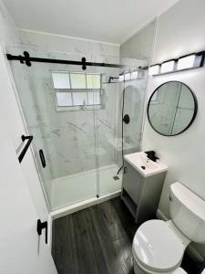 a bathroom with a shower and a toilet and a sink at Stylish 2/1 centrally located! in Miami