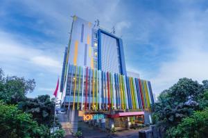 un edificio con tiras coloridas en el costado en 1O1 URBAN Jakarta Pemuda en Yakarta